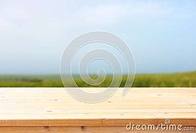 Wooden table and meadow background. ready food product display. Stock Photo