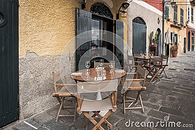 Wooden table near traditional Italian cafe in Portofino town, Italy Stock Photo