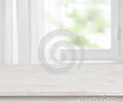 Wooden table surface on defocused half curtained window background Stock Photo