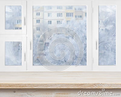 Wooden table surface over frosty window background Stock Photo