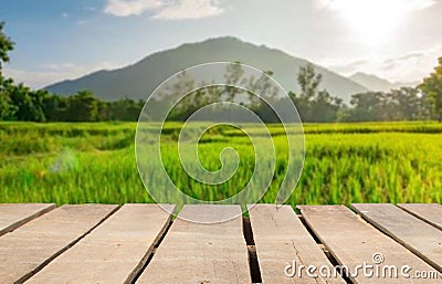 Wooden table top on blur rice field and mountain background.For place food,drink or health care business.fresh landscape and relax Stock Photo