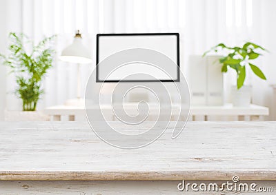 Wooden table top with blurred modern working place as background Stock Photo