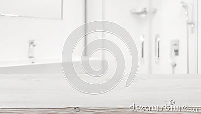 Wooden table top and blurred white bathroom interior as background Stock Photo