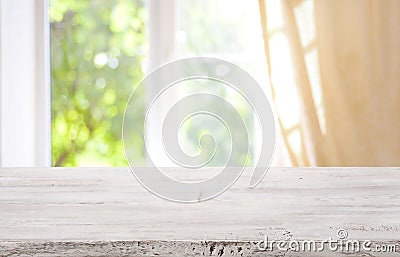 Wooden table top on blurred window background for product display Stock Photo