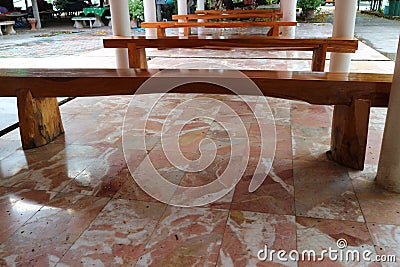Wooden tables arranged in a row of furniture for relaxing in the optional focus building. Stock Photo