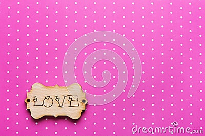 Wooden tag with word Love on pink Stock Photo