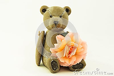 Wooden teddy bear with a rose Stock Photo