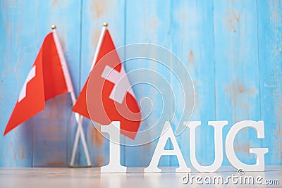 Wooden text of August 1st with miniature Switzerland flags. Switzerland National Day and happy celebration concepts Stock Photo