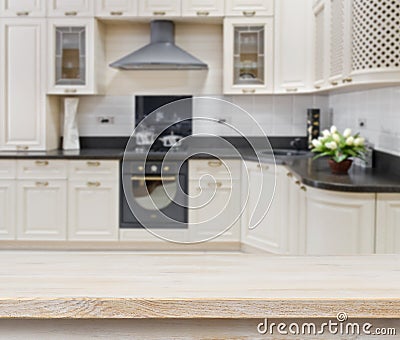 Wooden textured table over blurred kitchen interior background Stock Photo