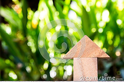 Wooden toy as dream house concept with blurred green background Stock Photo