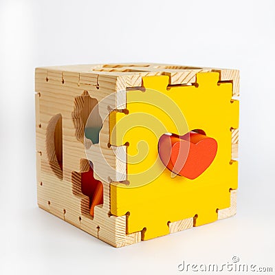 Wooden toy blocks cube shape sorter, colorful details isolated on white background, early development of logic for Stock Photo