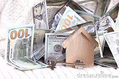 Wooden toy house with dollars cash money Stock Photo