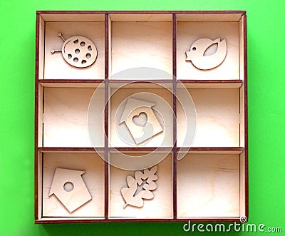 wooden toys in a box, spring coming concept. small birdhouses, bird, ladybug Stock Photo