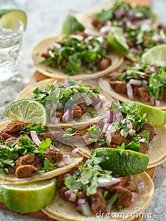 Wooden tray with carne asada tacos on corn tortilla Stock Photo