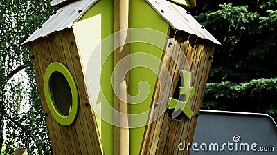 Wooden treehouse in playground with green plsatic window Stock Photo