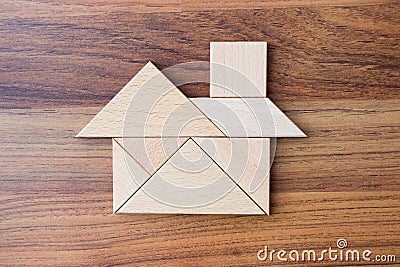 Wooden triangle puzzle or jigsaw build in home or house shape flat lay. Stock Photo