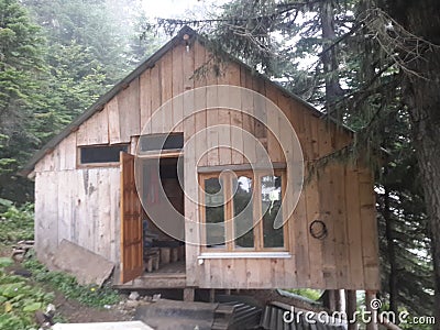 Wooden triangular house in the mountains Stock Photo