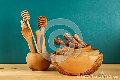 Wooden utensils. Wooden plates, cups, bowls. Dishes on shelf. Kitchenware Stock Photo