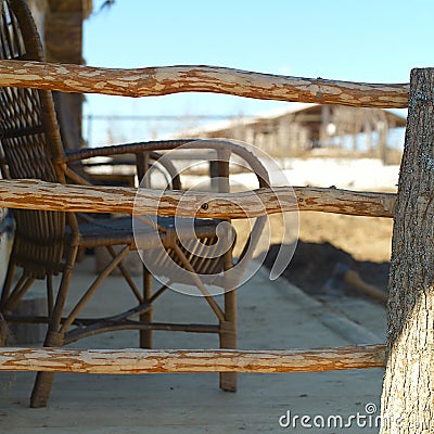 Wooden veranda with a wicker chair Stock Photo