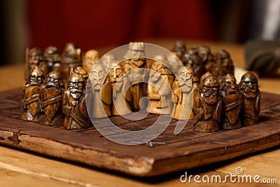 Wooden Viking chess hnefatafl on a wooden carved board made of dark wood Stock Photo