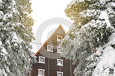 wooden village rural house,mansion,hotel covered in snow,icicles in winter forest mountains Stock Photo