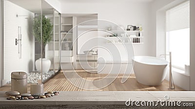 Wooden vintage table top or shelf with candles and pebbles, zen mood, over blurred minimalist bathroom with shower and walk-in clo Stock Photo