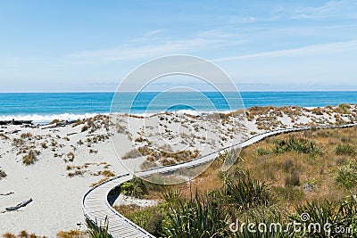 Wooden walking path over sand beach w Stock Photo