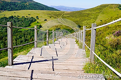 Wooden walking path in puy de dome french mountains in summer day Stock Photo
