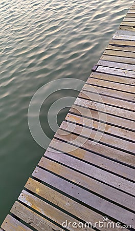 Wooden walkway along the pond Stock Photo