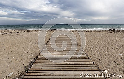 Wooden walkway on the beach of Bol Nou Stock Photo