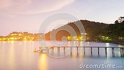 Wooden walkway leading to sea port night view Stock Photo