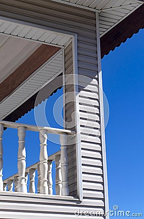 Wooden wall cladding on column, concrete beam and under the roof. Detail from balcony terrace. Stock Photo