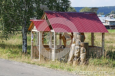 Wooden well and statues of the three Russian heroes Editorial Stock Photo