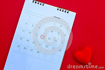 Wooden white calendar with date February 14 and beautiful red hearts on bright red background. Romantic date. Concept Valentine`s Stock Photo