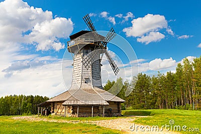 Wooden windmill on background sky with clouds. Naroch lake, Myadel Region, Belarus Stock Photo
