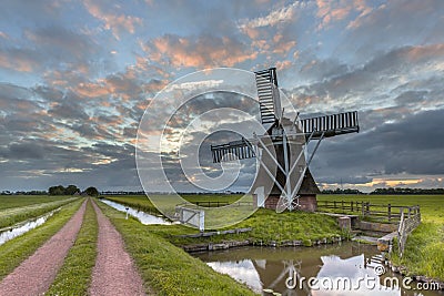 Wooden windmill road Stock Photo