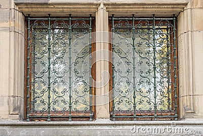 Wooden windowframe with classic designed metal grid Stock Photo
