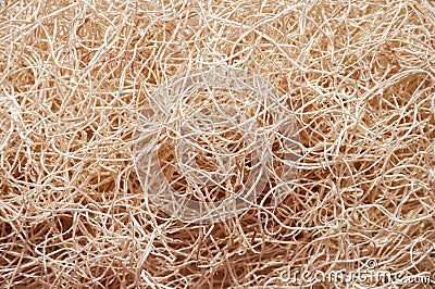 Wooden wool fibers close up background.Shredded wood excelsior for filling inside.Natural sustainable material for wrapping. Stock Photo