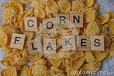Wooden word lies on a pile of dry cornflakes Stock Photo