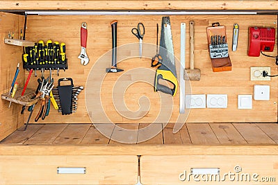 Wooden workbench at workshop. Lot of different tools for diy and repair works. Wood desk for product display. Copyspace. Labour da Stock Photo