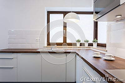 Wooden worktops and white cupboards Stock Photo