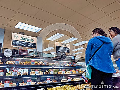 Customers shopping at the deli department in a Haggen Northwest Fresh grocery store Editorial Stock Photo