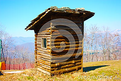 Woodshed in the mountains or storage room built in logs to store things Stock Photo