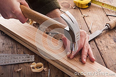 Woodworker hammer a nail Stock Photo
