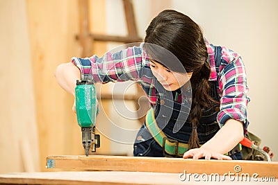 Woodworker using air compressor nail Stock Photo