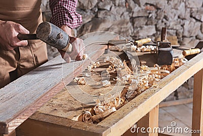 Woodworker using chisel to smooth down wood Stock Photo