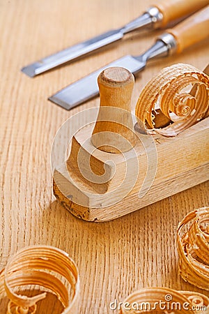 Woodworkers plane with chisel and wooden shavings on board Stock Photo