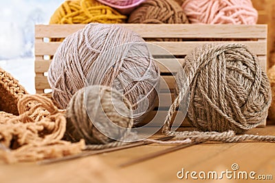 Woolen yarn and fabric on the window sill. Beautiful view outside the window - winter scenery and snow Stock Photo