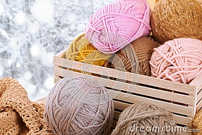 Woolen yarn and fabric on the window sill. Beautiful view outside the window - winter scenery and snow Stock Photo