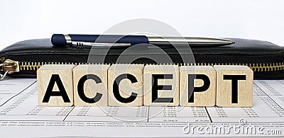 A word Accept written in a wooden cube with a pen and wallet Stock Photo